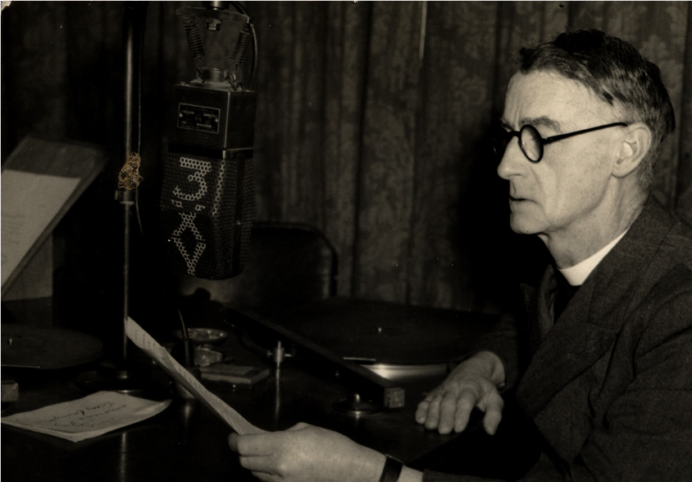 This photo shows Father Tucker at the microphone at 3XY radio station in the 1950s